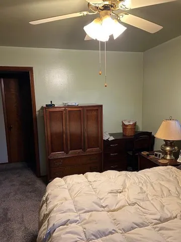a bed room with a bed and a chandelier