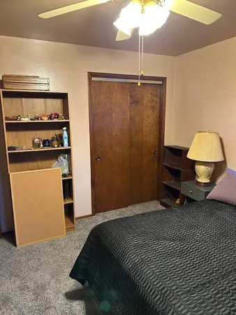 a bedroom with bed and a chandelier