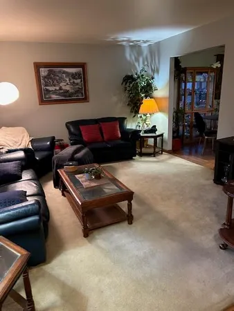 a living room with furniture a window and bookshelf