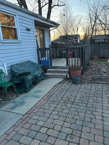 a view of a bench with wooden fence