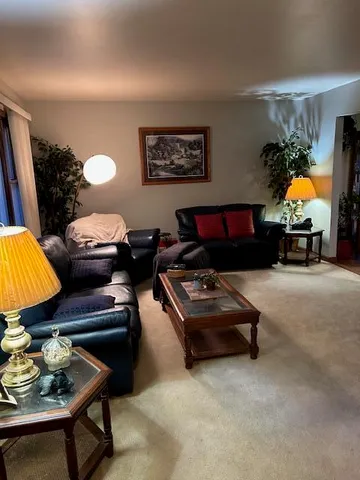 a living room with furniture and a lamp