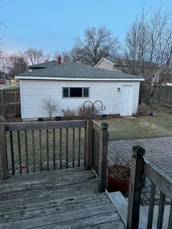 a view of a wooden deck and a backyard