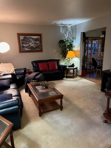 a living room with furniture gym equipment and a flat screen tv