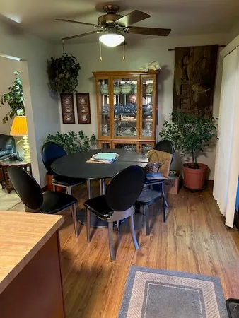 a view of a dining room with furniture and wooden floor