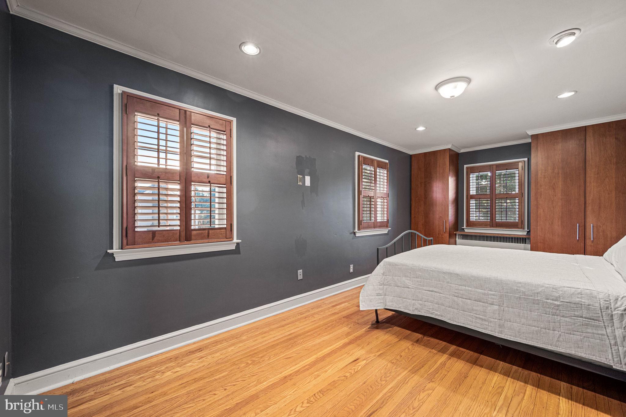 601 South Eagle Road Havertown, PA 19083 - Photo 19 of 32 a bedroom with a large bed chandelier and a window