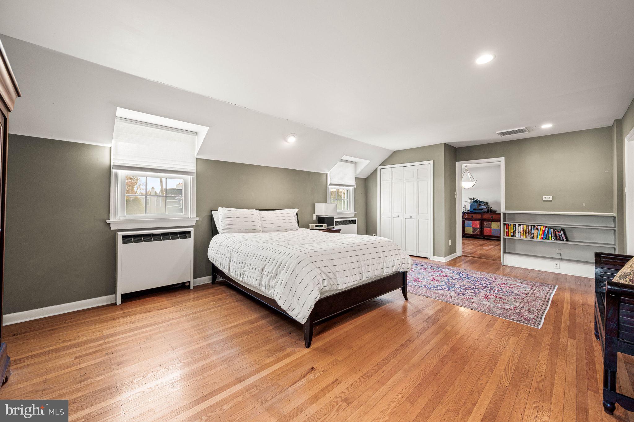 601 South Eagle Road Havertown, PA 19083 - Photo 24 of 32 a spacious bedroom with a bed and a wooden floor