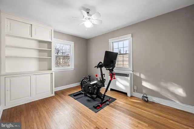 a view of workspace with wooden floor windows