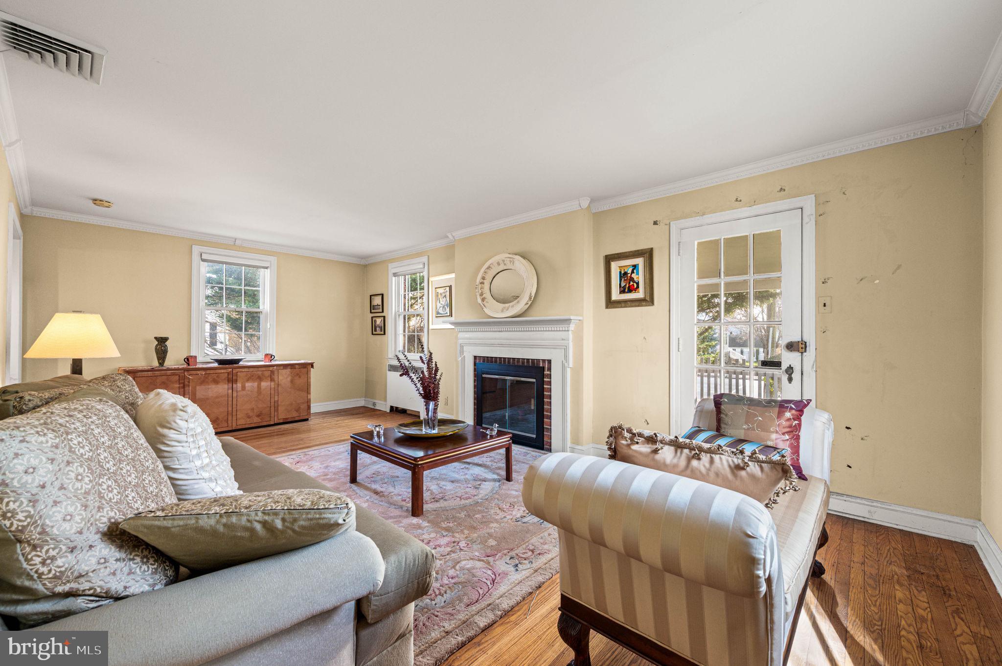 601 South Eagle Road Havertown, PA 19083 - Photo 6 of 37 a living room with furniture a fireplace and a window