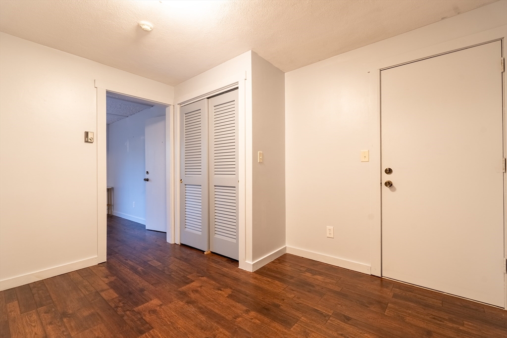 23 Spencer Road, Unit 20F Boxborough, MA 01719 - Photo 3 of 7 an empty room with wooden floor