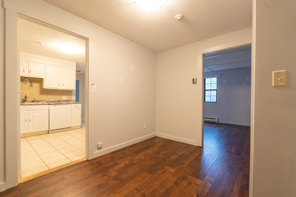 23 Spencer Road, Unit 20F Boxborough, MA 01719 - Photo 4 of 7 a view of a kitchen with wooden floor and a kitchen