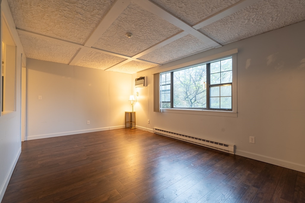 23 Spencer Road, Unit 20F Boxborough, MA 01719 - Photo 5 of 7 an empty room with wooden floor and windows