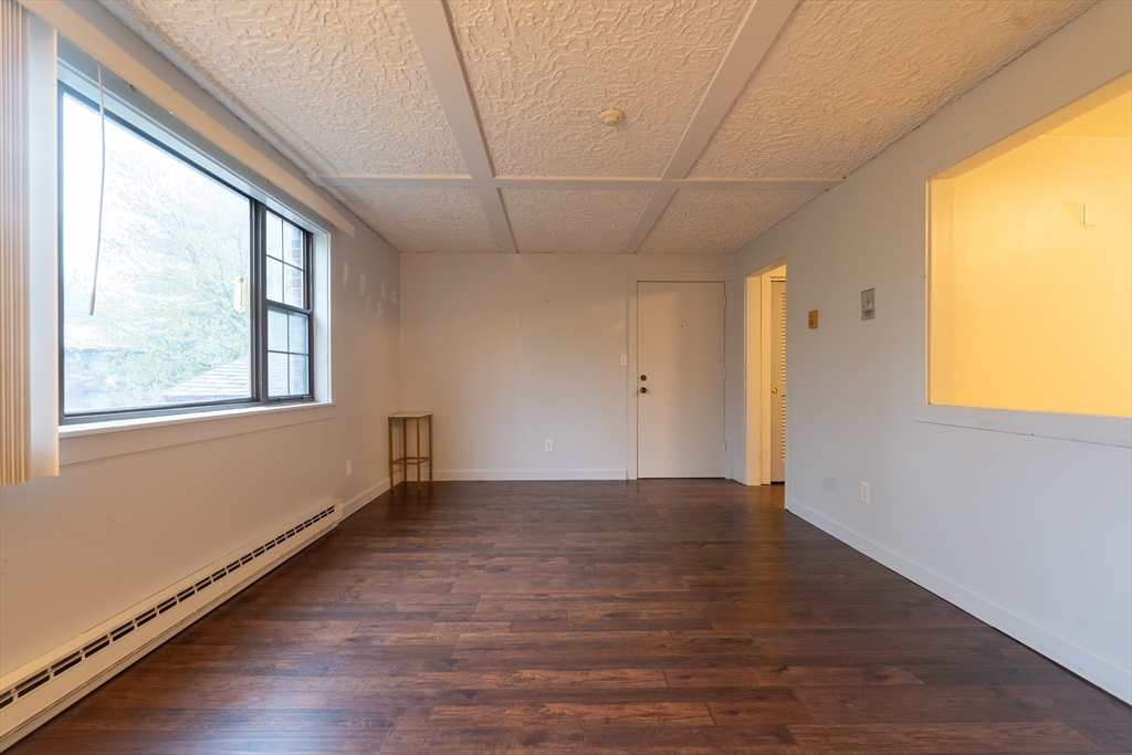23 Spencer Road, Unit 20F Boxborough, MA 01719 - Photo 6 of 7 a view of an empty room with wooden floor and a window