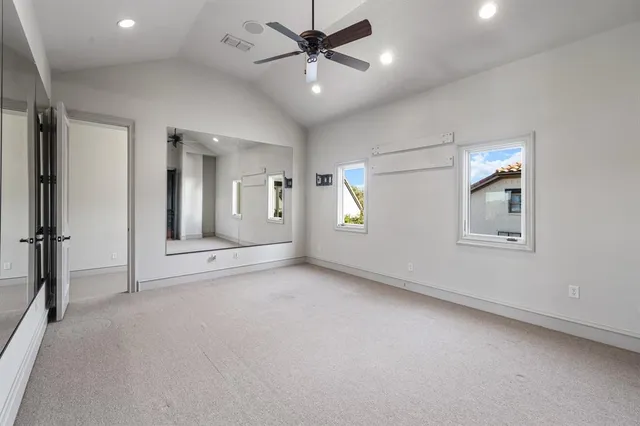 an aerial view of a house with a garden and lake view