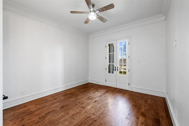 an empty room with wooden floor and fireplace