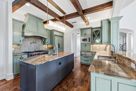 a kitchen with granite countertop a stove and a sink