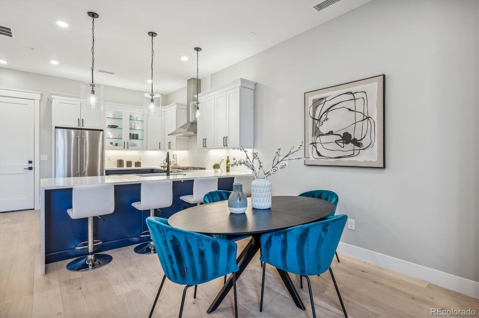 a dining room with furniture and wooden floor