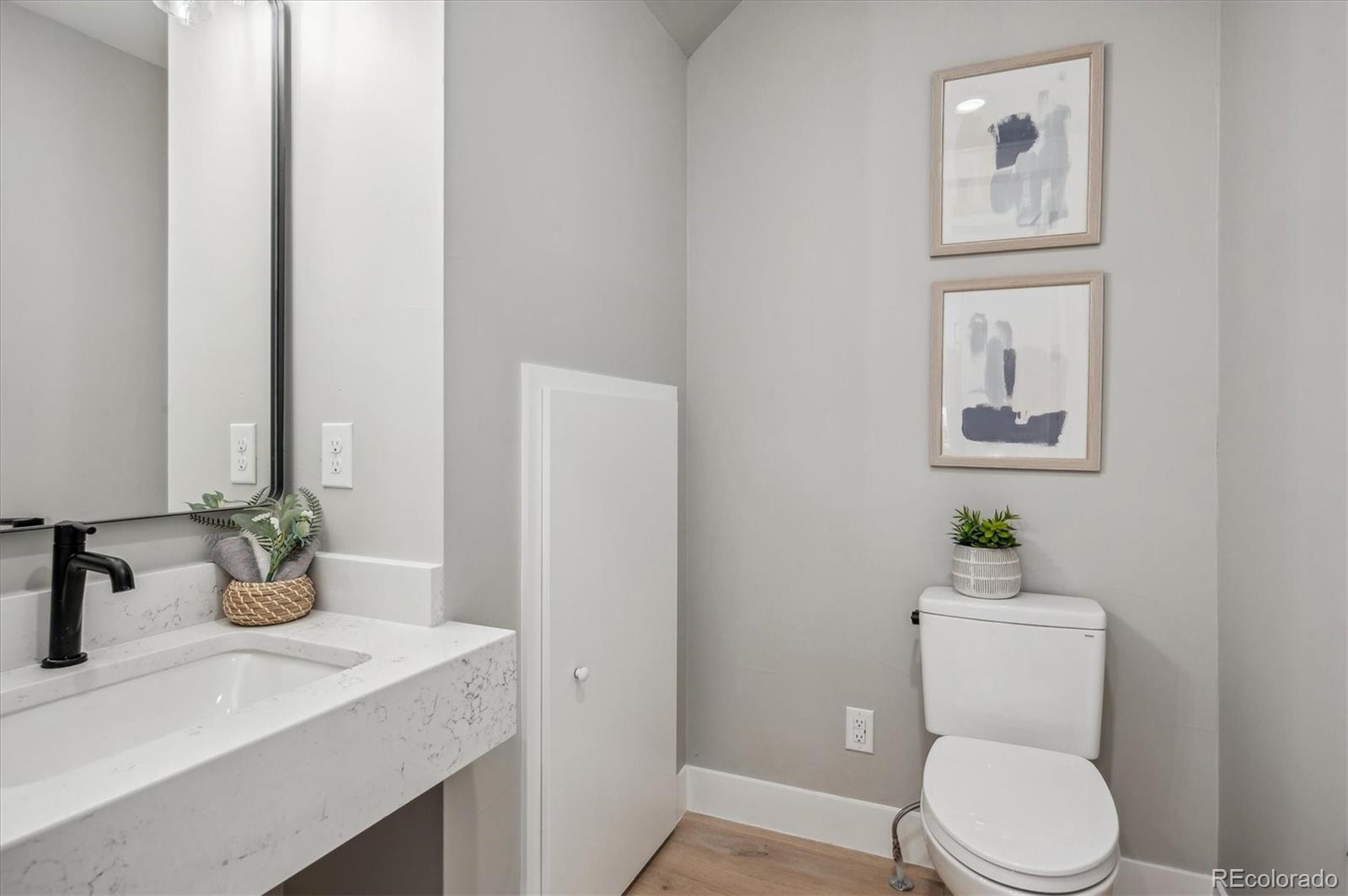 364 East Orchard Road Centennial, CO 80121 - Photo 12 of 30 a bathroom with a toilet a sink and mirror