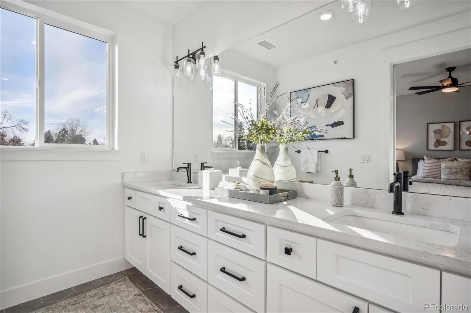 364 East Orchard Road Centennial, CO 80121 - Photo 18 of 30 a bathroom with double vanity sink a window and a mirror