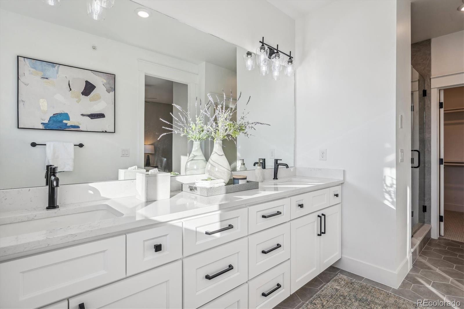 364 East Orchard Road Centennial, CO 80121 - Photo 19 of 30 a bathroom with a double vanity sink and a mirror