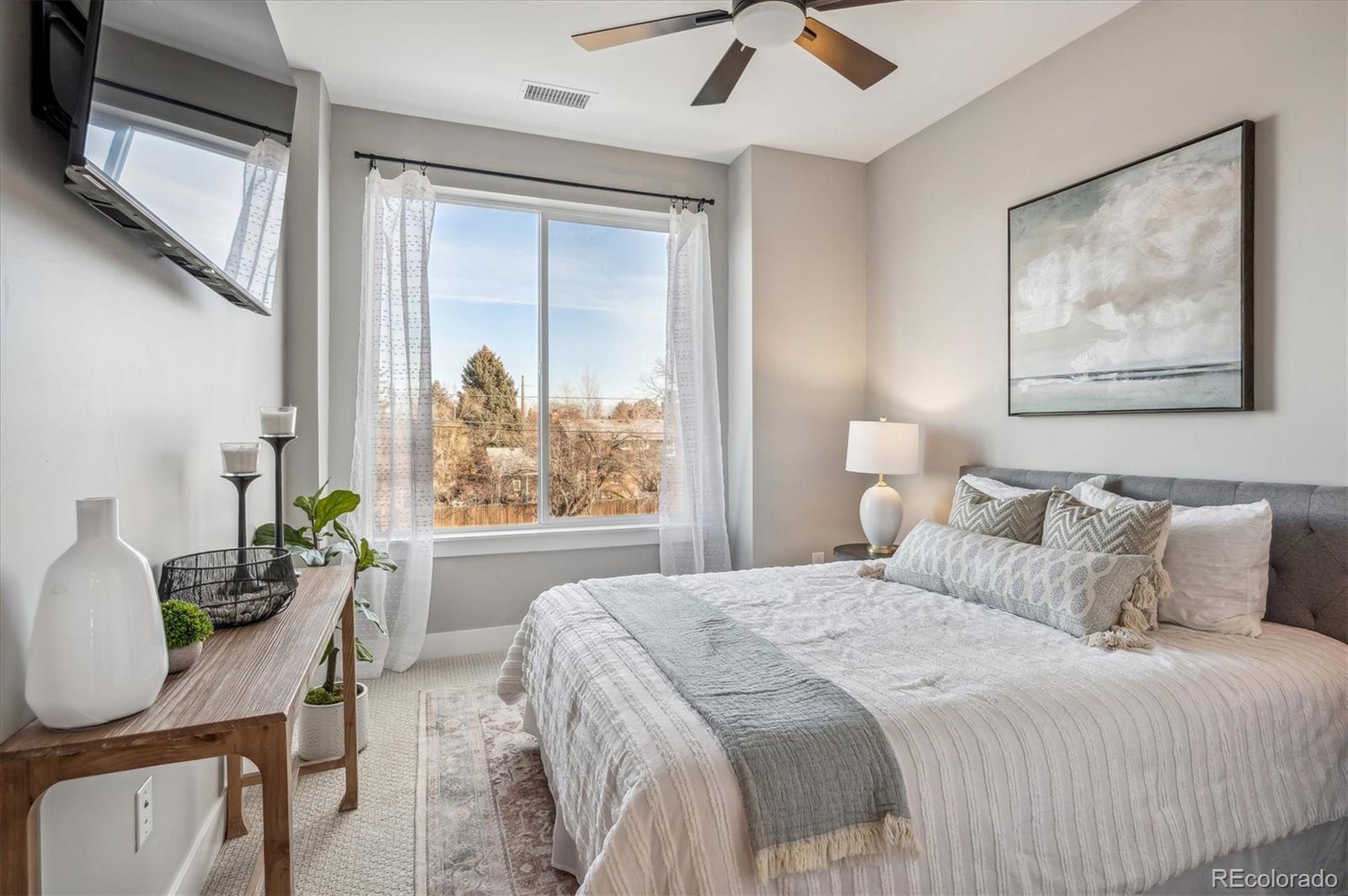 364 East Orchard Road Centennial, CO 80121 - Photo 22 of 30 a bedroom with a bed and a painting on the wall