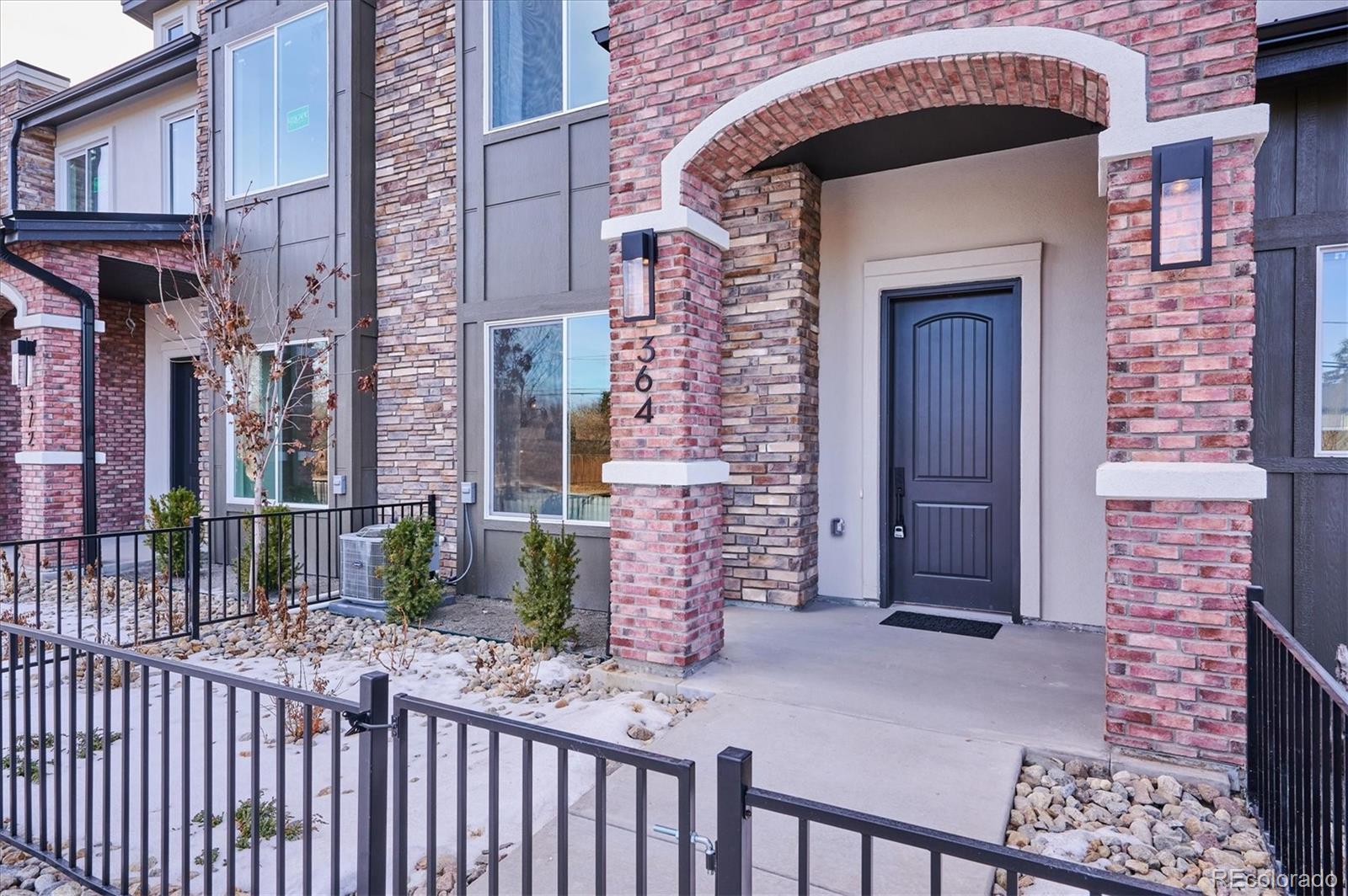 364 East Orchard Road Centennial, CO 80121 - Photo 27 of 30 a front view of a house with a iron gate
