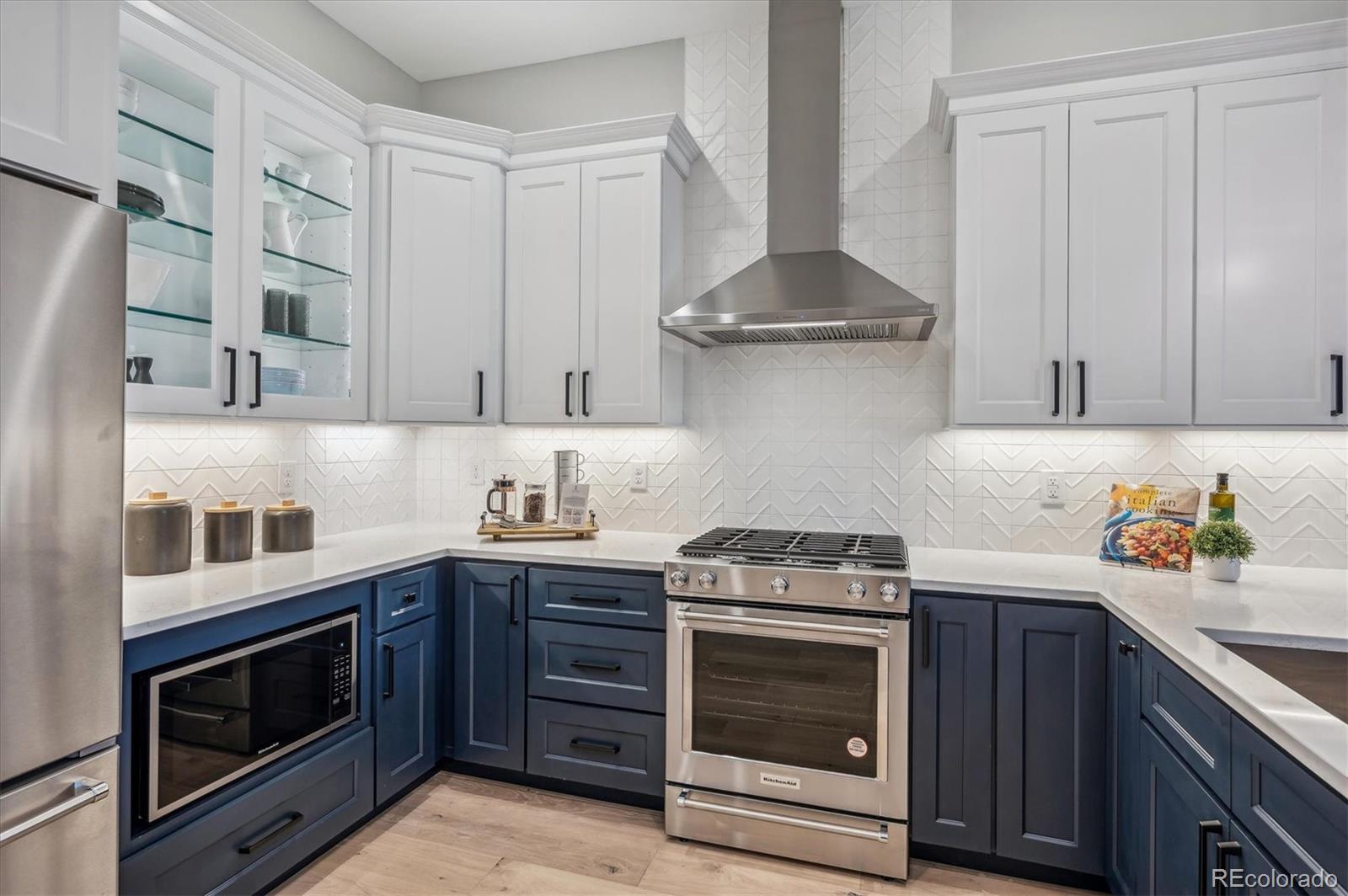 364 East Orchard Road Centennial, CO 80121 - Photo 10 of 30 a kitchen with stainless steel appliances granite countertop a stove and a microwave