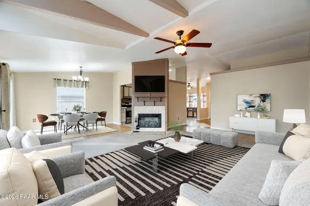 a living room with furniture a fireplace and a flat screen tv