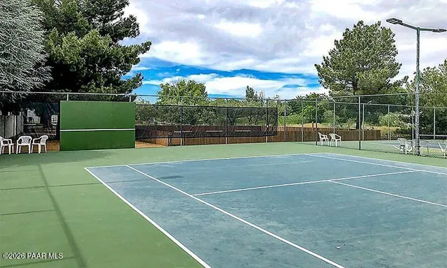 a kitchen with stainless steel appliances granite countertop a sink a stove and a wooden floors
