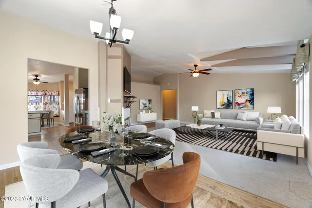 a living room with furniture a chandelier and a table