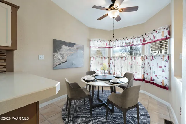 a dining room with furniture and window