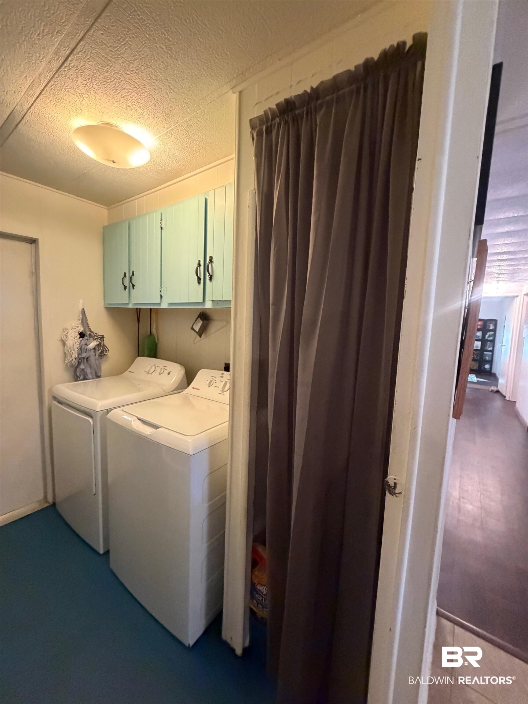 1430 Ridgewood Drive Lillian, AL 36549 - Photo 15 of 34 Laundry area with cabinet space, washing machine and dryer, and a textured ceiling