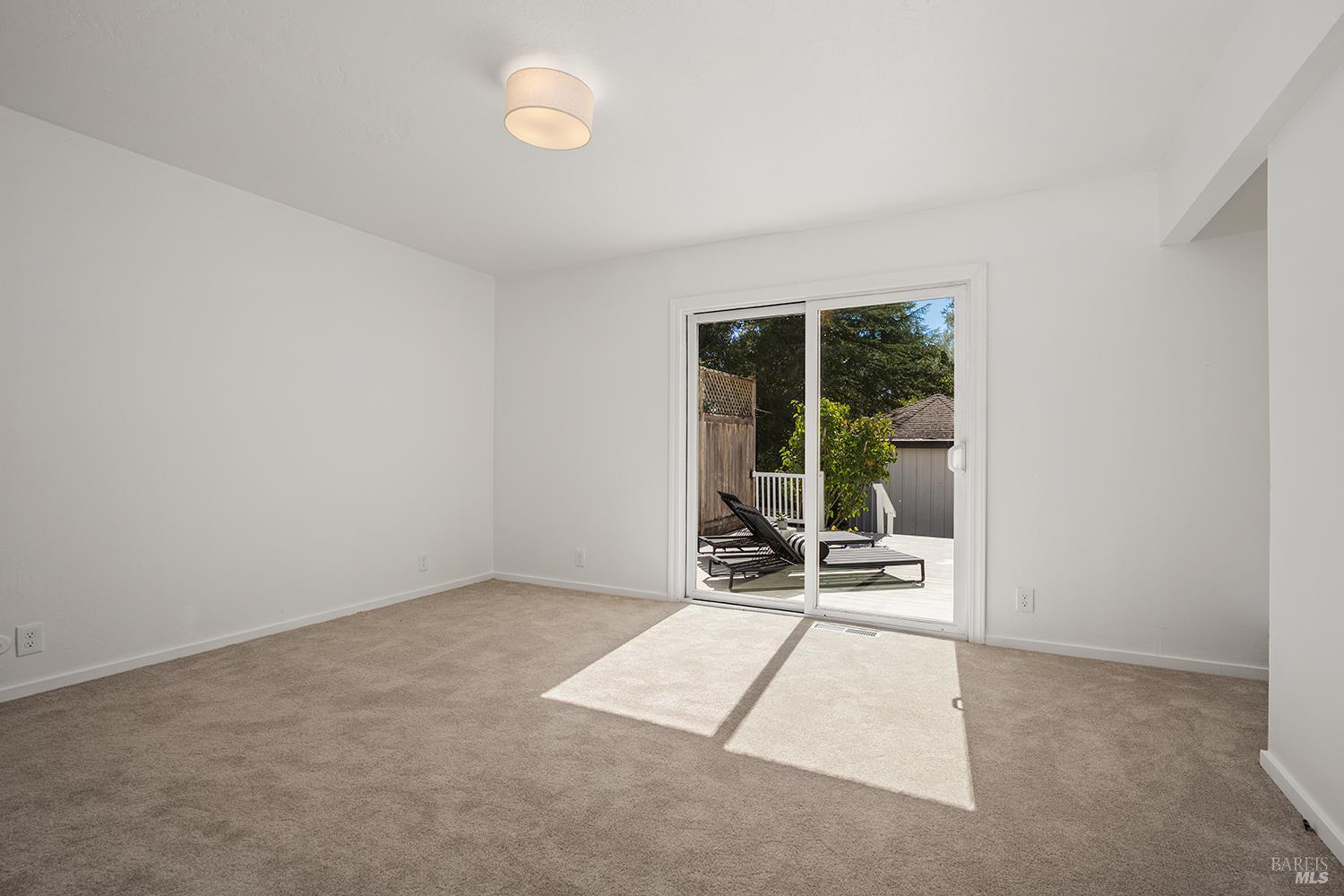 1470 High School Road Sebastopol, CA 95472 - Photo 24 of 54 Downstairs primary bedroom with full bath and access to outdoor deck.