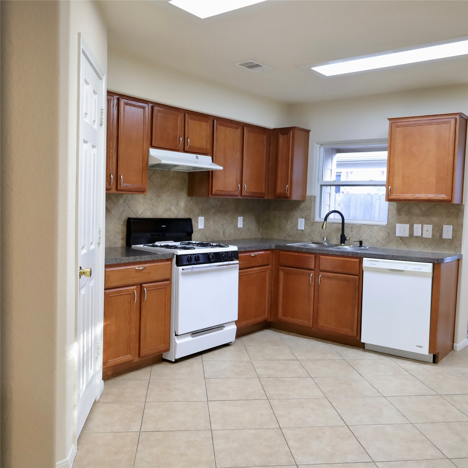 2419 Stiller Ridge Way Spring, TX 77386 - Photo 6 of 14 a kitchen with stainless steel appliances granite countertop a sink counter space cabinets and a window