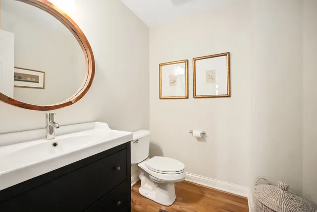 a bathroom with a toilet a sink and mirror