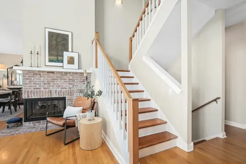 a view of a livingroom with furniture and staircase