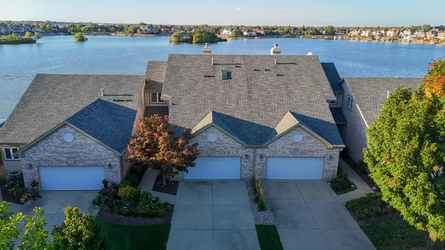an aerial view of a house with a yard and a large pool