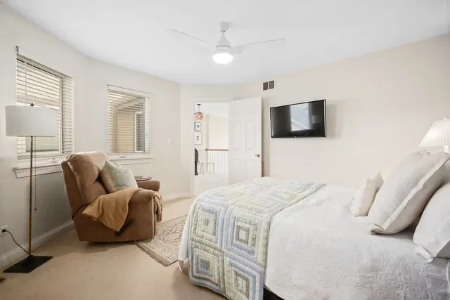 a bedroom with a bed and flat screen tv