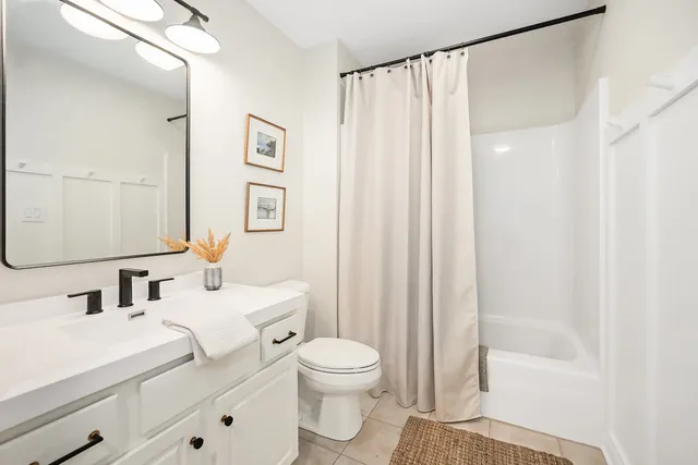 a bathroom with a toilet a sink and a mirror