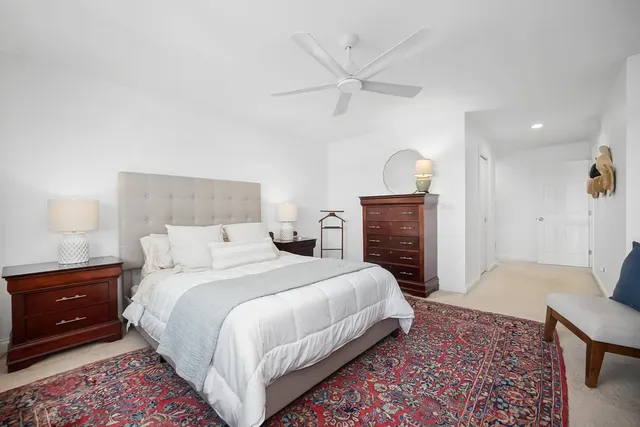 a white bath tub sitting next to a shower