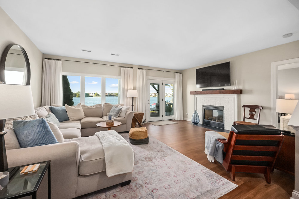 22864 Harbour Lane Plainfield, IL 60544 - Photo 31 of 65 a living room with furniture a fireplace and a flat screen tv