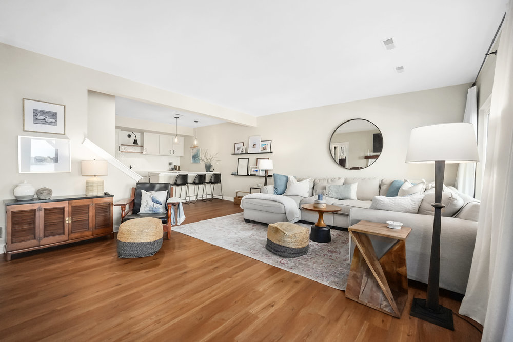 22864 Harbour Lane Plainfield, IL 60544 - Photo 35 of 65 a living room with lots of white furniture and a wooden floor