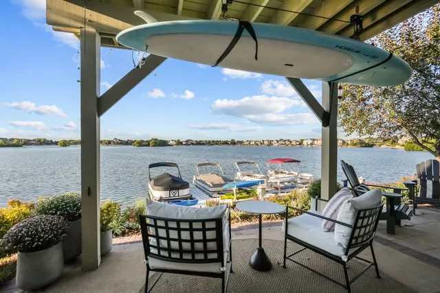 an aerial view of a house with swimming pool a yard and a patio