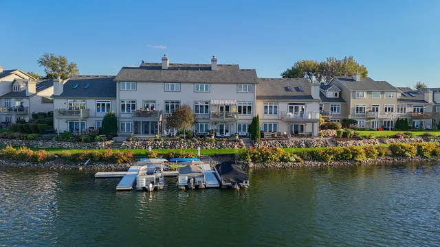 a view of a lake with houses in back