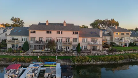 a view of residential house with outdoor space and lake