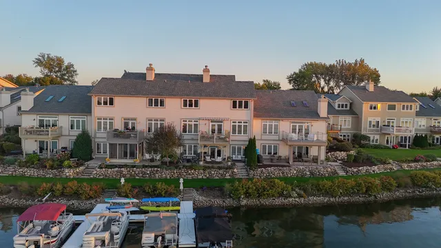 a view of residential house with outdoor space and lake