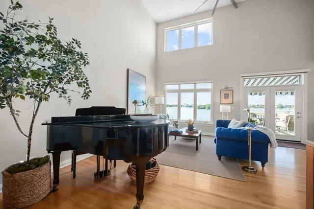 a living room with furniture and a floor to ceiling window