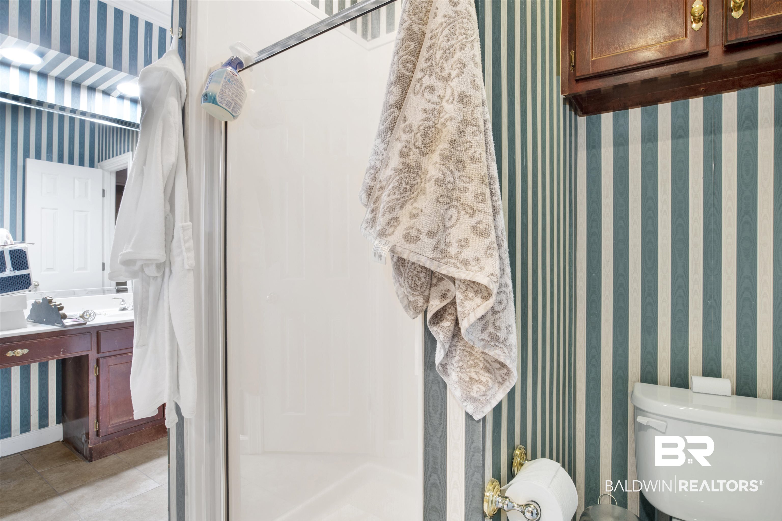 445 Wedgefield Drive South Mobile, AL 36608 - Photo 22 of 36 Bathroom featuring tile patterned flooring, vanity, toilet, and walk in shower