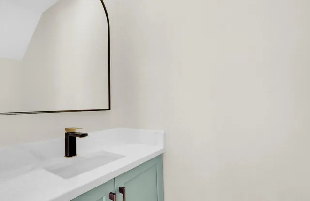 a bathroom with a sink and mirror