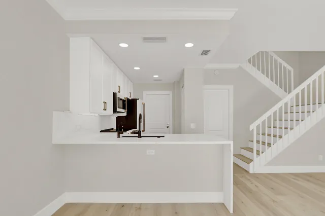 a view of kitchen with microwave and refrigerator