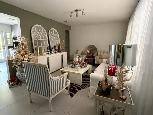 a kitchen with stainless steel appliances granite countertop a table chairs and a refrigerator